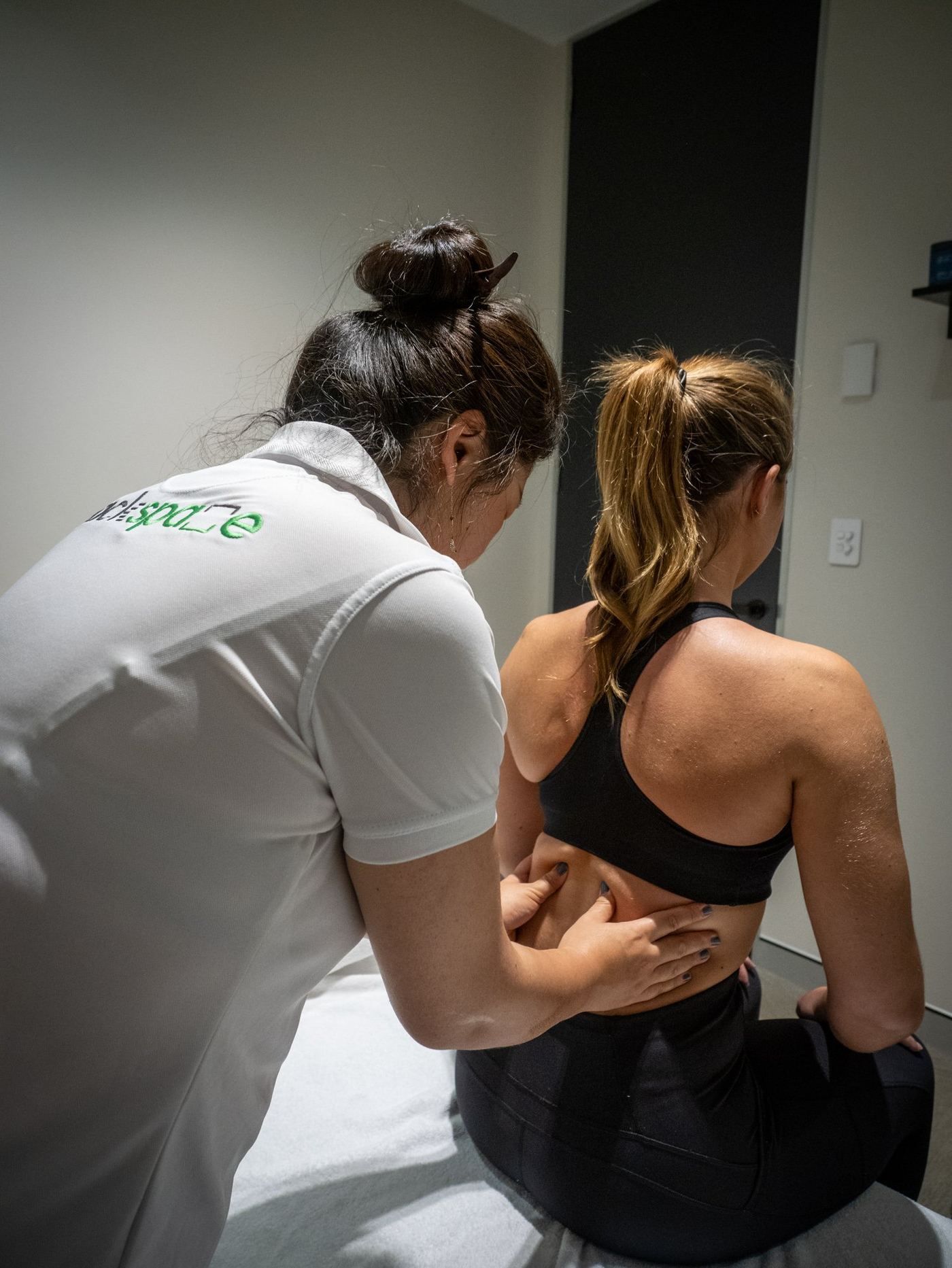 A therapist giving a patient remedial massage of the back